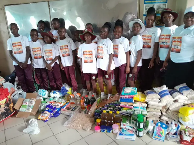 Learners and adults standing with collected supplies